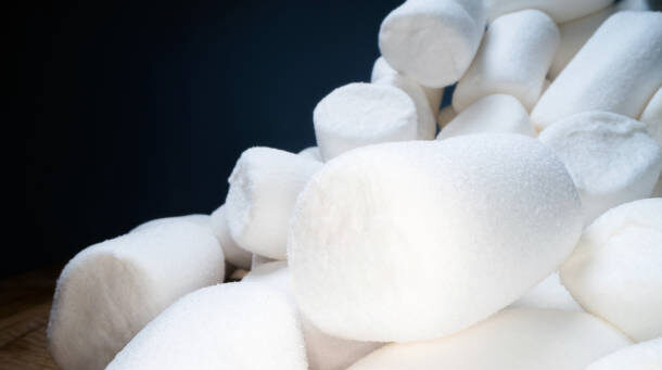 Pile of sweet and soft marshmallow. Yummy white sweets on dark background, fast food